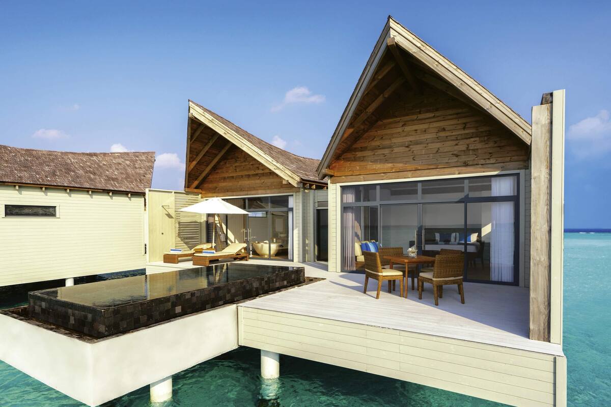 Overwater bungalows with infinity pools, wooden deck, and a view of the ocean.