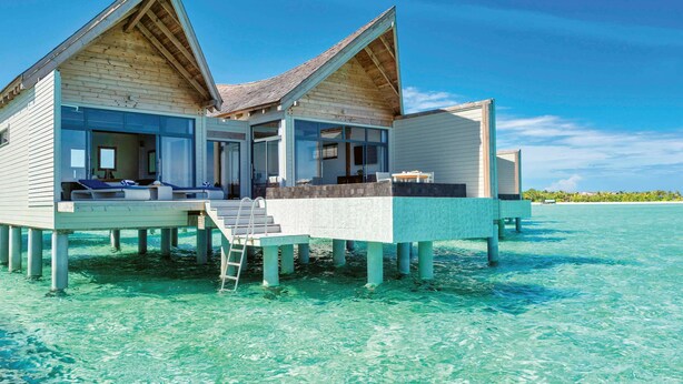 A two-story overwater bungalow with a balcony, clear blue water, and a wooden exterior. - Kuredhivaru Resort & Spa Maldives by Accor (Kuredhivaru)