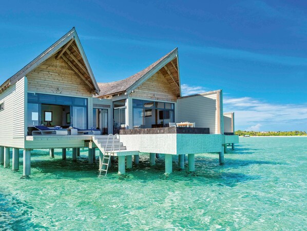 A two-story overwater bungalow with a balcony, clear blue water, and a wooden exterior. - Kuredhivaru Resort & Spa Maldives by Accor (Kuredhivaru)