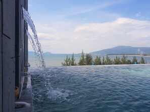 Outdoor pool, open 6 AM to 10 PM, pool loungers - Santori Hotel Danang Bay (Da Nang)