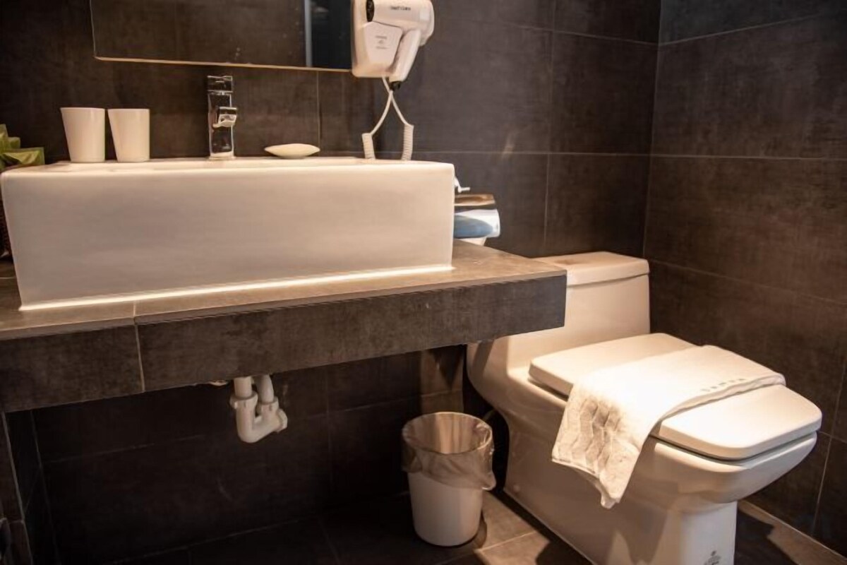 Bathroom | Shower, rainfall showerhead, hair dryer, slippers