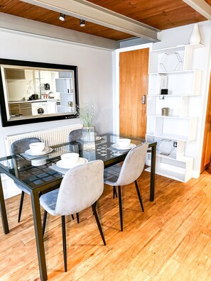 Enjoy meals in this stylish dining area with a glass-top table and comfortable seating for four.