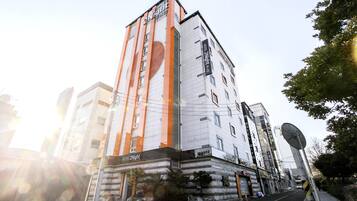 A hotel with a modern design, featuring a prominent orange and white color scheme.