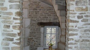 A stone staircase with a small window at the top. - Le Puits Fortifie (Salives)