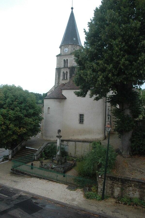 A church with a tall steeple and a clock.