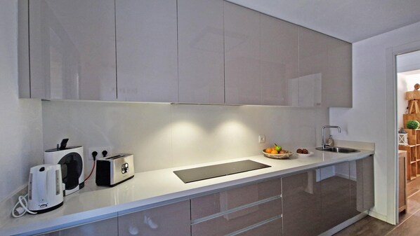 A modern kitchen with a sleek countertop, built-in appliances, and a minimalist design.