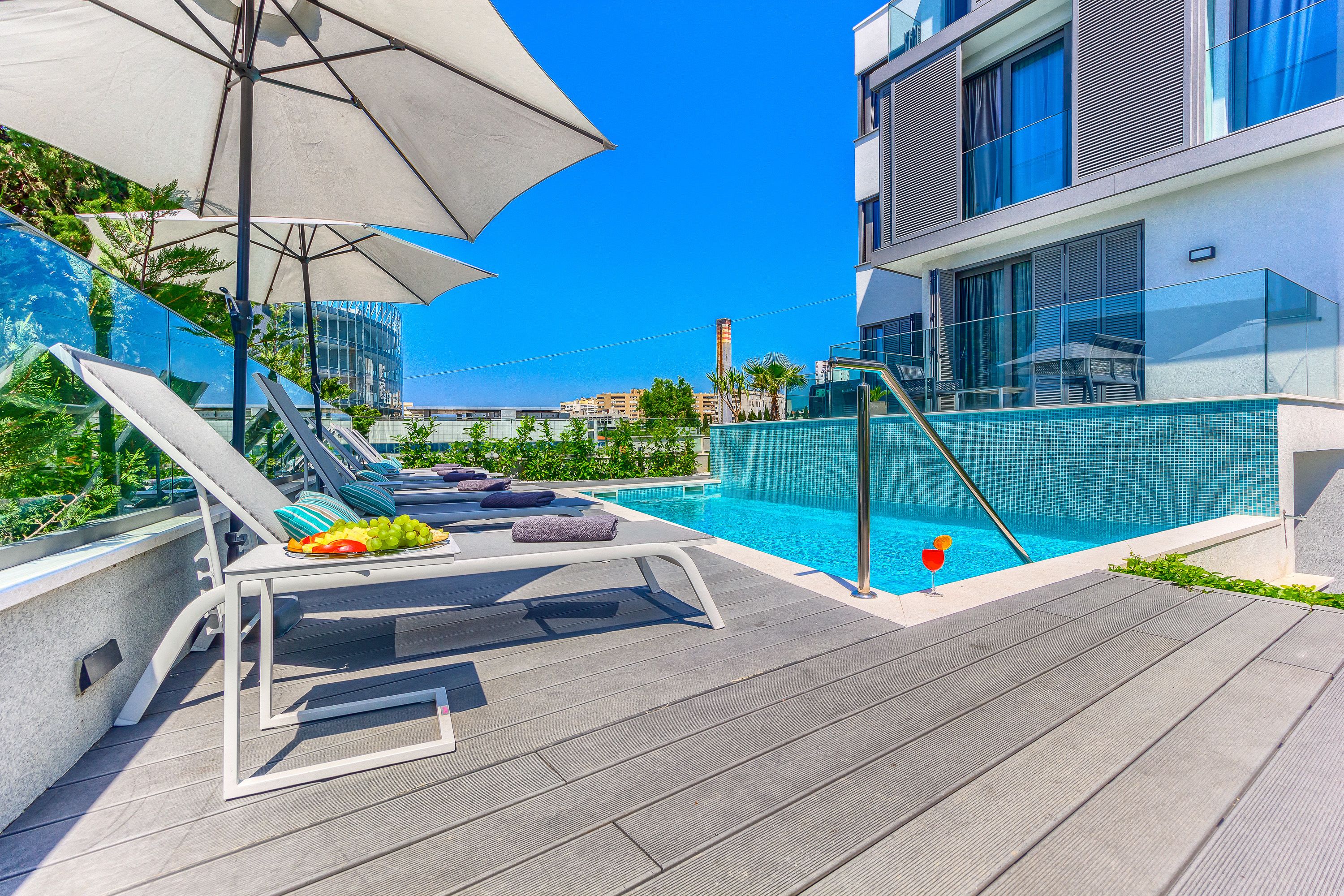 seasonal outdoor pool, open 8:00 am to 8 pm, pool umbrellas