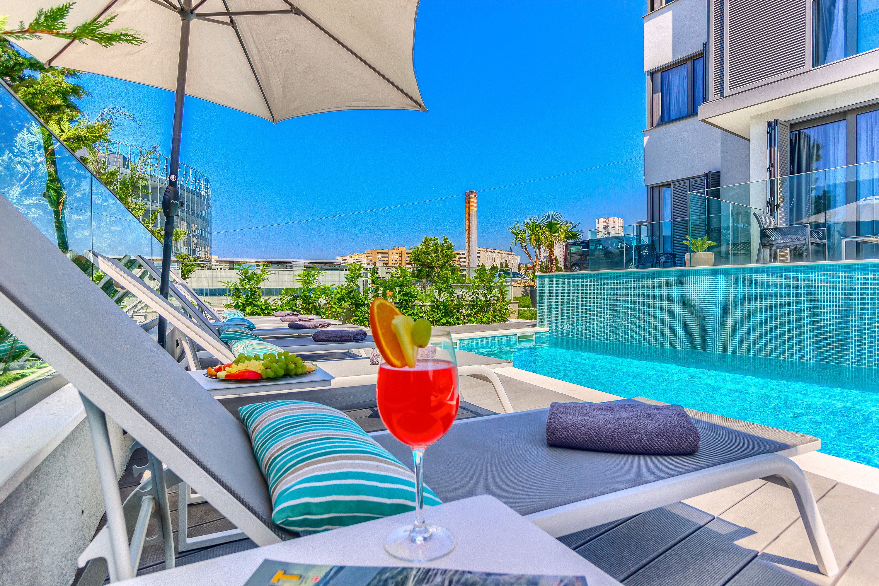 Seasonal outdoor pool, open 8:00 AM to 8 PM, pool umbrellas