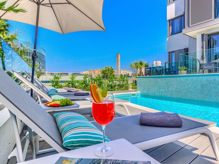 Seasonal outdoor pool, open 8:00 AM to 8 PM, pool umbrellas