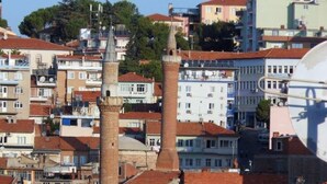 A densely packed urban area with multi-story buildings, some featuring traditional brick structures and others with modern designs. - Hotel Sungur (Demirci)