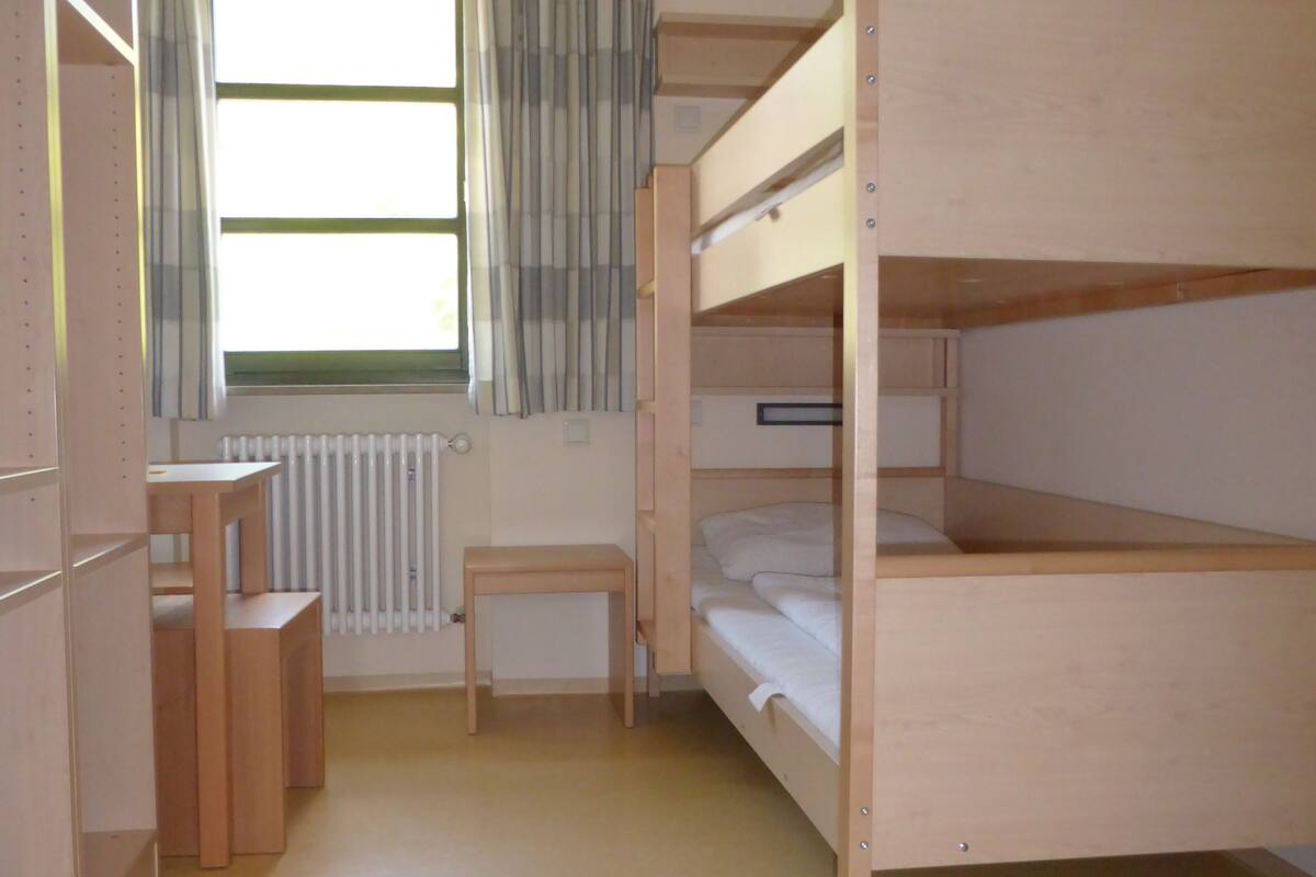 Desk, laptop workspace, bed sheets