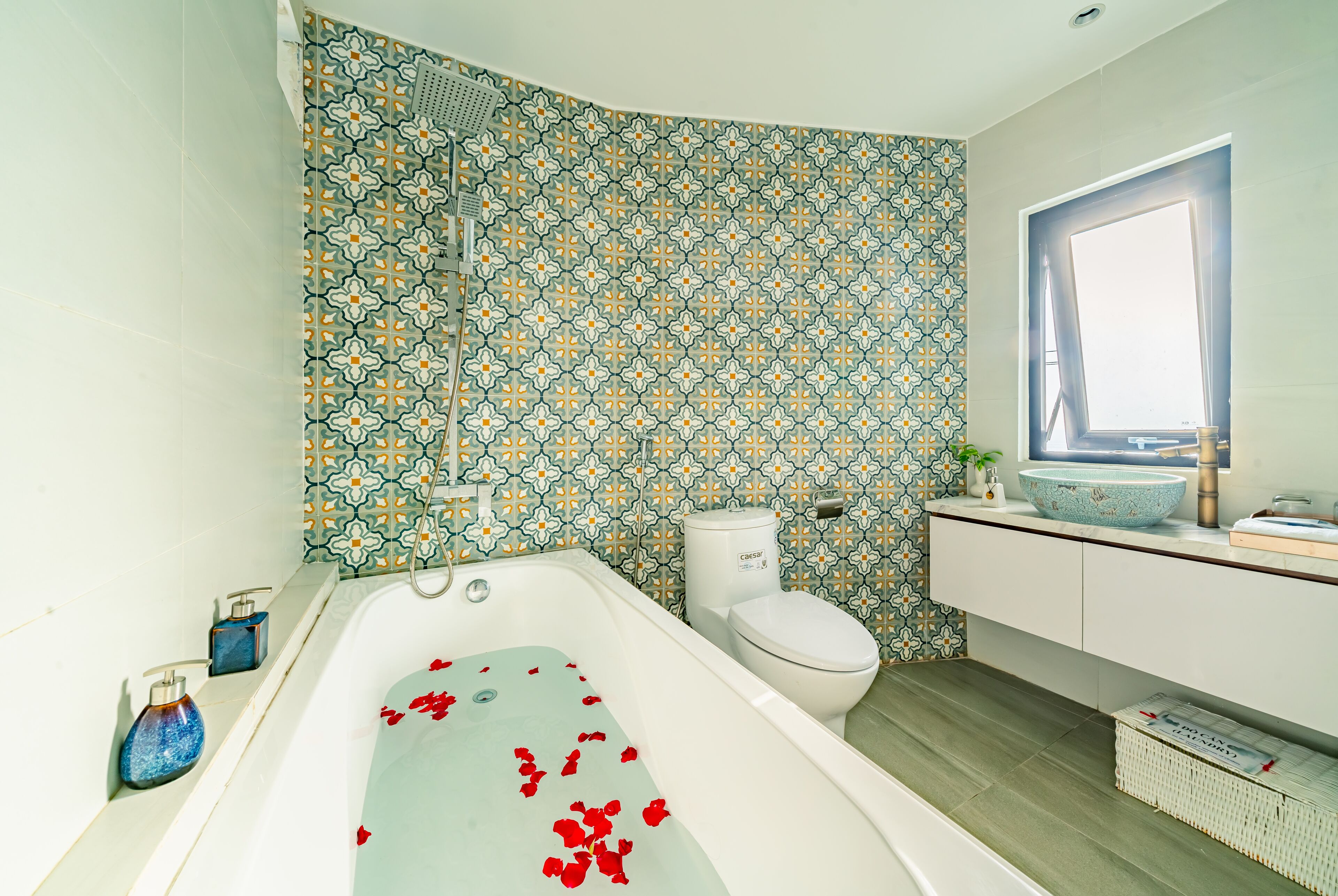 A bathroom with a bathtub, toilet, and sink.