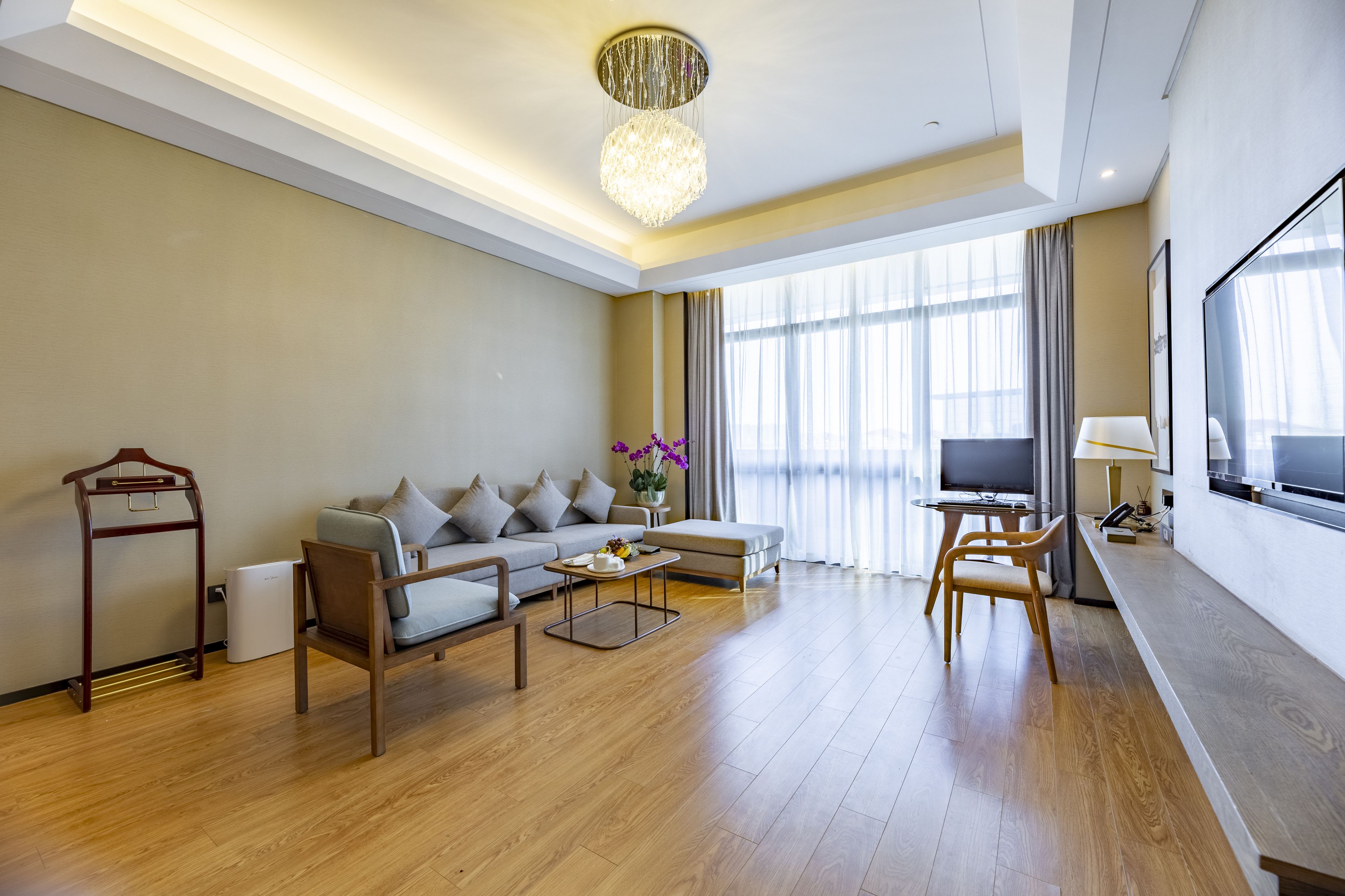 A modern living room with a sofa, coffee table, and TV.