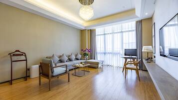 A modern living room with a sofa, coffee table, and TV.