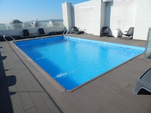 Seasonal outdoor pool, open 8:00 AM to 8:00 PM, pool loungers