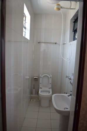 Basic Double Room Single Use, 3 Bedrooms | Bathroom | Shower, free toiletries, bathrobes, bidet - Covitech Apartments (Nairobi)