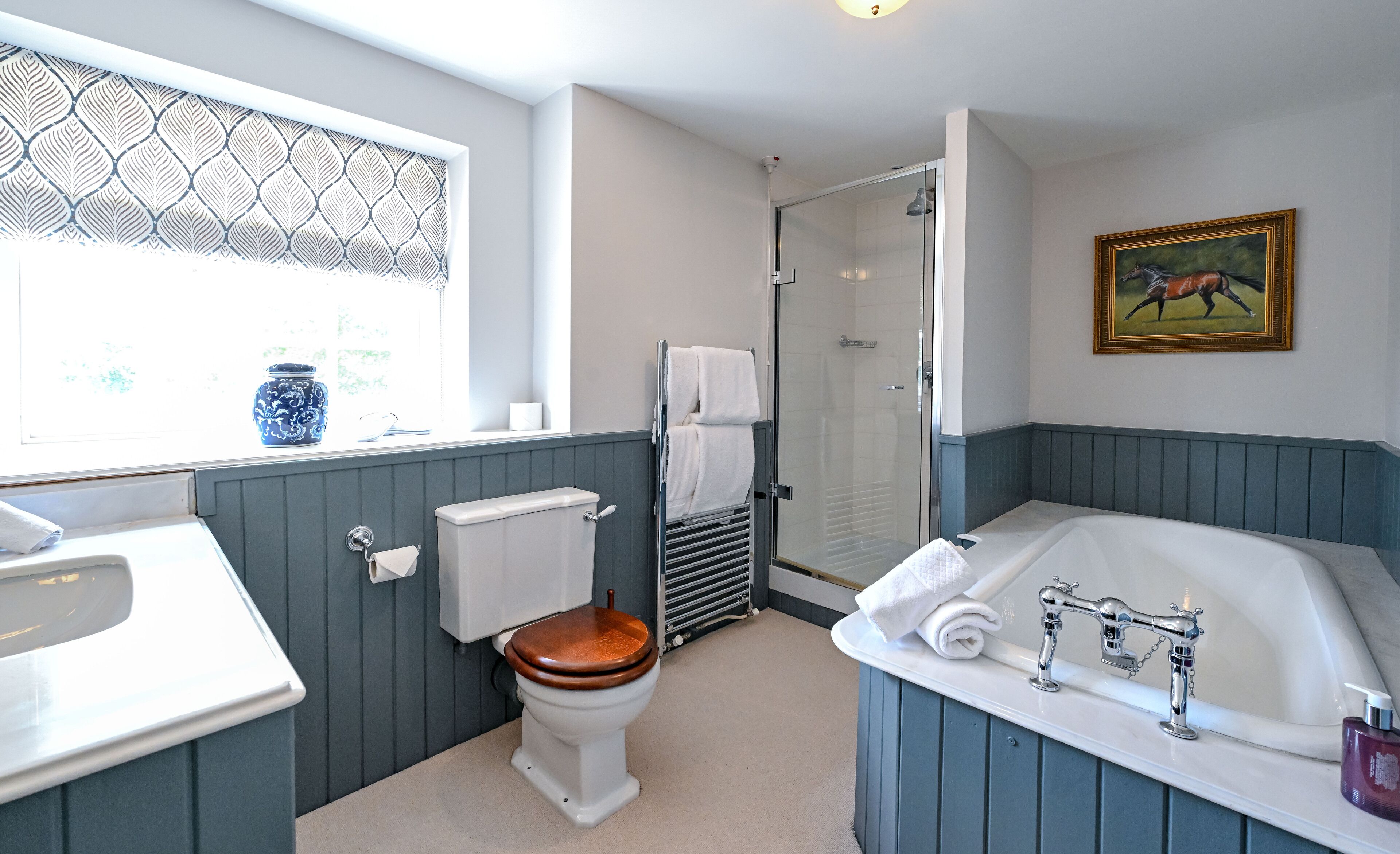 A bathroom with a toilet, sink, bathtub, and a shower.