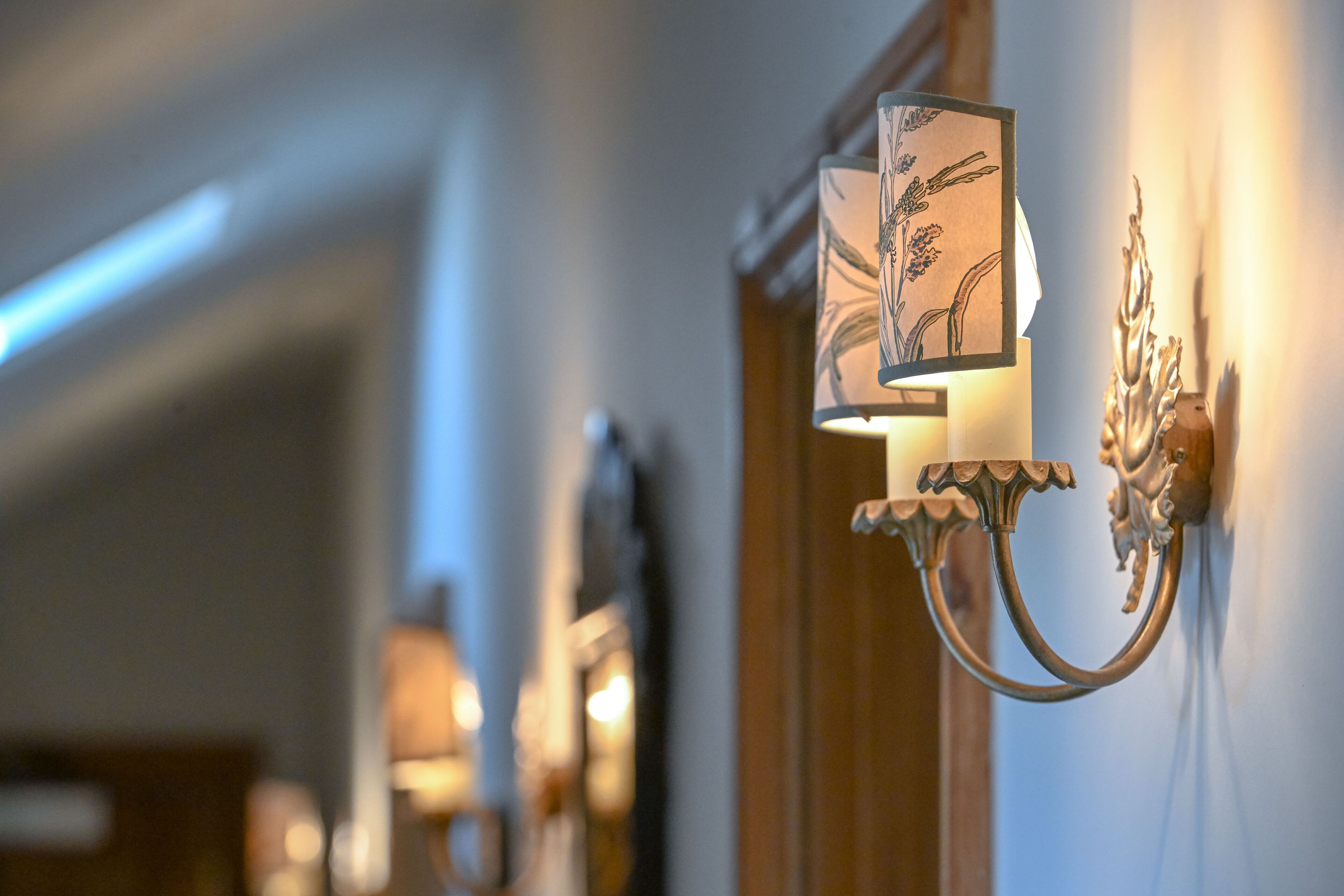 A wall-mounted light fixture with a decorative design.