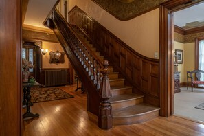 Stunning staircase with ornate balusters and a sturdy handrail, leading to an upper floor.