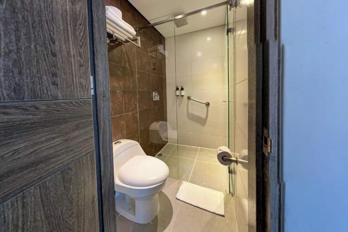 deluxe room | bathroom | hair dryer, towels, shampoo, toilet paper