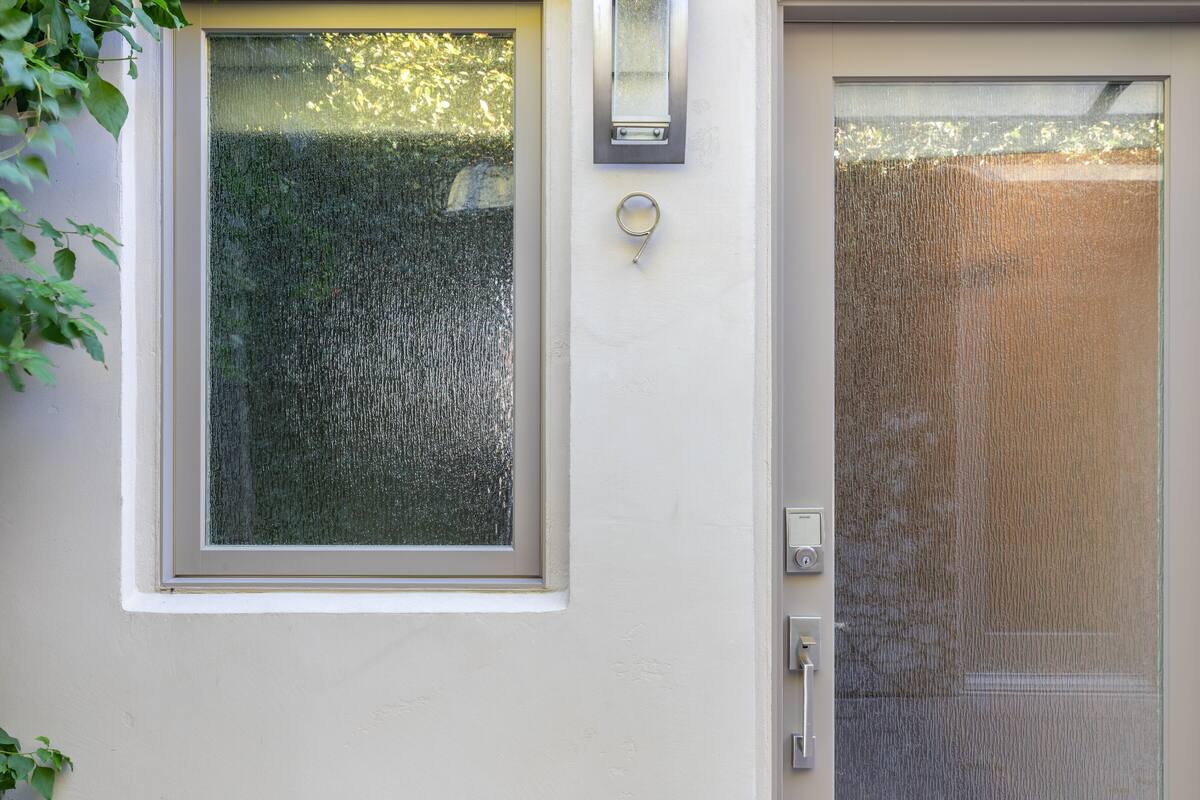 A house with a window and a door, both with glass panels.