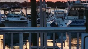 A marina with boats docked at wooden piers, under a sunset sky. -  24 hour gated community Beach House , Surfside Beach  SC (Surfside Beach)
