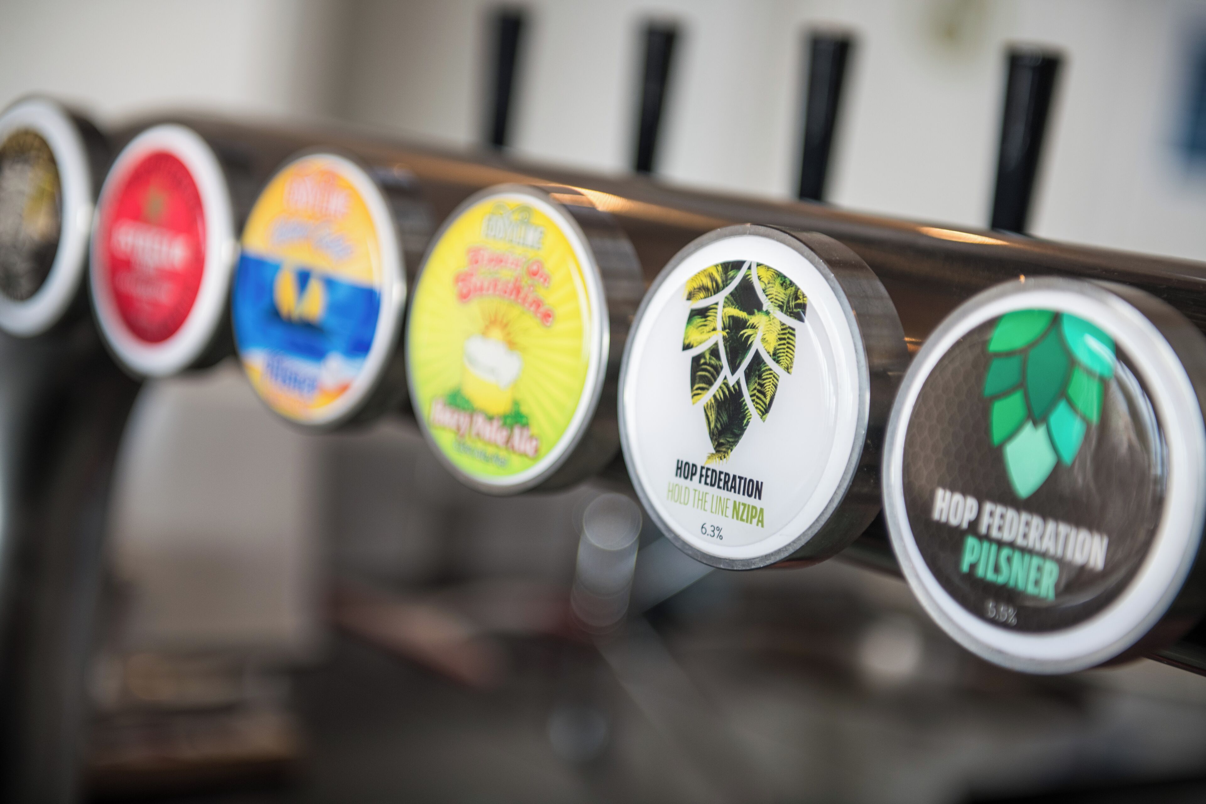 A beer tap with a hop federation logo and a 6.3% alcohol by volume label.