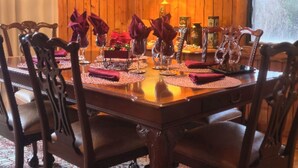 A wooden dining table set with red napkins, glassware, and a centerpiece. - 2 BD/2BA  LOG HOME 1 1/2 MI To SDC 500 YDS TO TABLE ROCK LAKE 15 MIN TO BRANSON (Branson)