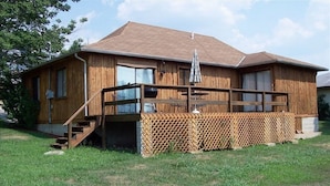A wooden house with a deck, a staircase, and a fenced area. - 2 BD/2BA  LOG HOME 1 1/2 MI To SDC 500 YDS TO TABLE ROCK LAKE 15 MIN TO BRANSON (Branson)