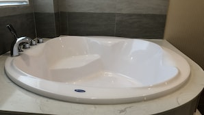 A modern bathroom with a freestanding bathtub, a single faucet, and a marble countertop. - Moc Lan 1 Hotel (Ho Chi Minh City)