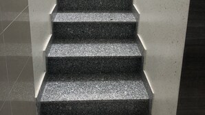 A staircase with granite steps and a metal railing, leading to an upper floor. - Moc Lan 3 Hotel (Ho Chi Minh City)