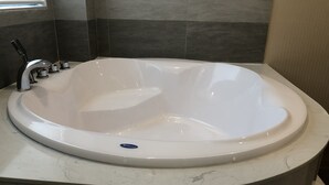 A modern bathroom with a freestanding bathtub, a single faucet, and a marble countertop. - Moc Lan 3 Hotel (Ho Chi Minh City)