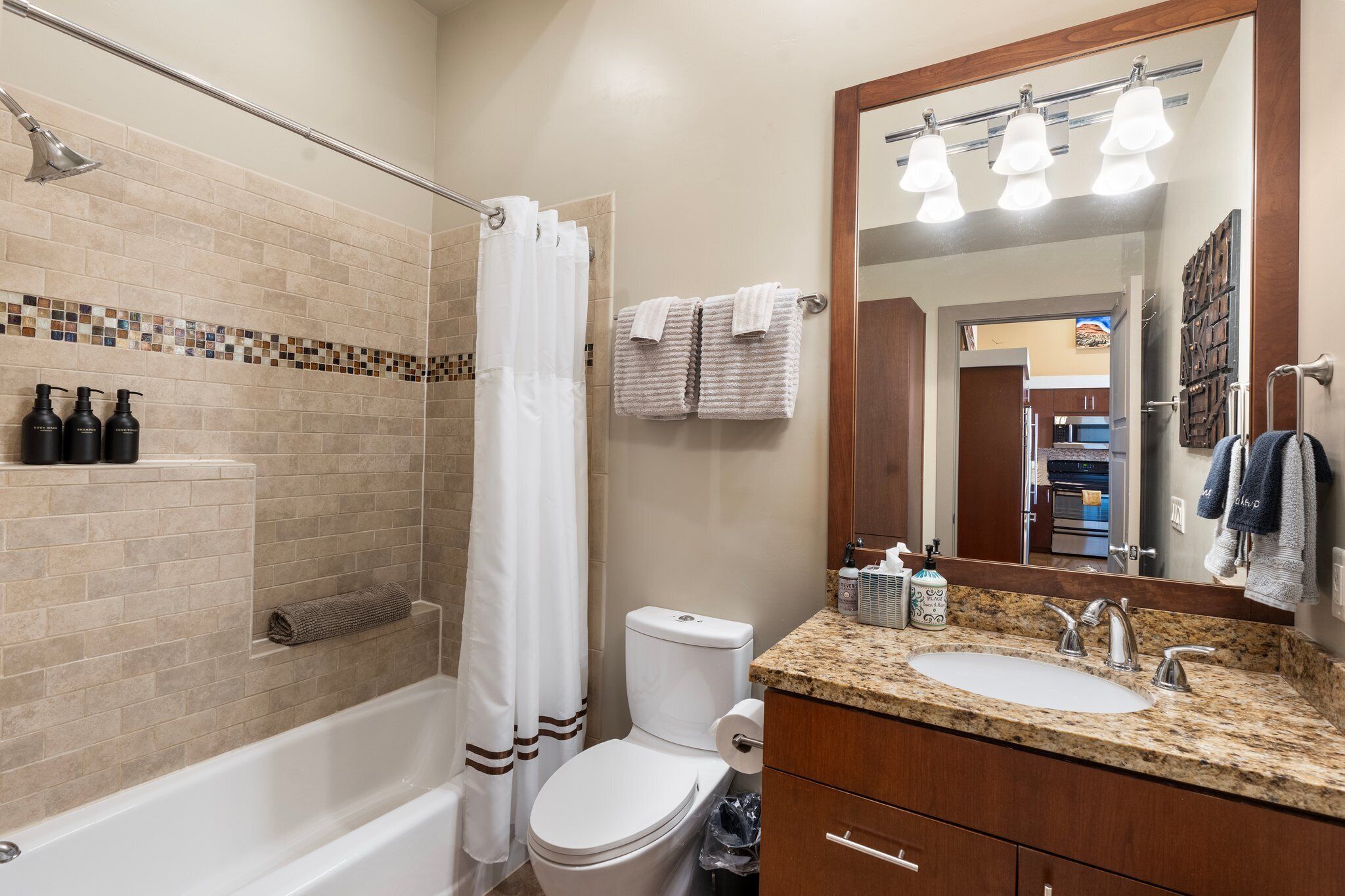 A bathroom with a bathtub, toilet, and sink.