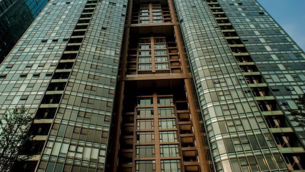 A high-rise building with a central atrium and multiple floors. - Guangzhou Yiyuan Apartment (Guangzhou)