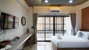 A hotel room with a bed, a desk, a chair, a TV, and a window with curtains. - Luck Esan Loft - Hostel (Ubon Ratchathani)