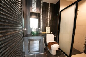 A modern bathroom with a toilet, sink, and shower. - The Ananas Serviced Apartments (Karon)