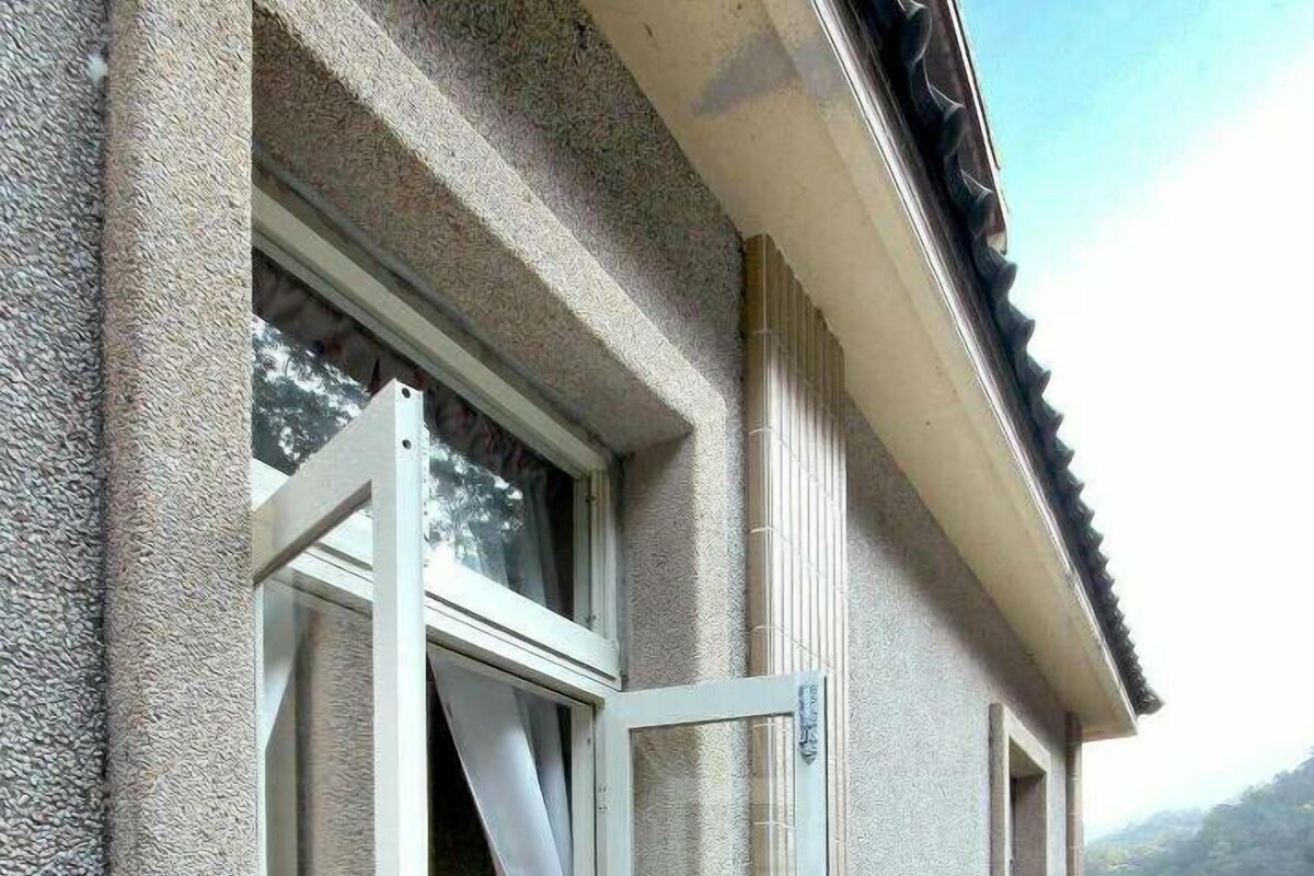 A wooden deck with a glass door leading to a balcony.