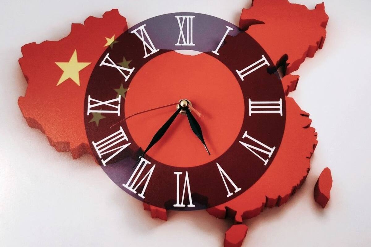 A clock with a map of China and the Chinese flag.