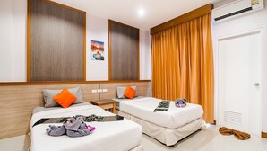 A hotel room with two beds, a large window with curtains, an air conditioning unit, and a door with a vent. - Phusamor Hotel (Trang)