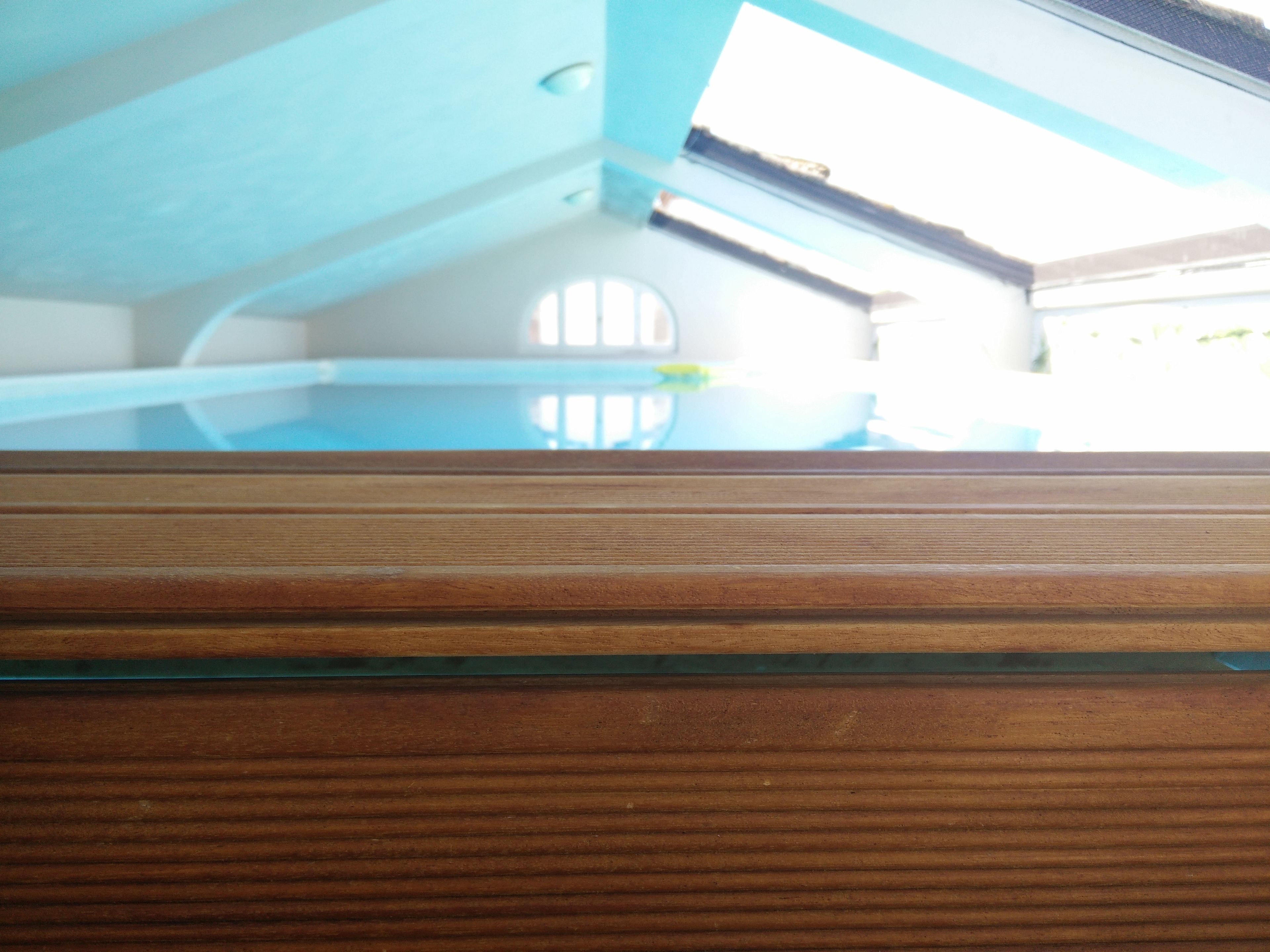 A wooden floor with a glass panel.
