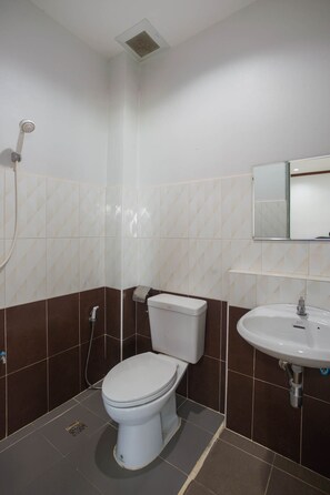 A bathroom with a toilet, sink, and shower.