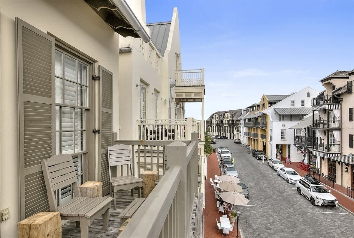 Vista de una calle con edificios, aceras y coches estacionados.