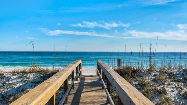 A wooden boardwalk leading to a beach with clear blue water and a bright sky. - Portside S "beauty And The Beach" 3 Bedroom Townhouse by RedAwning (Pensacola Beach)