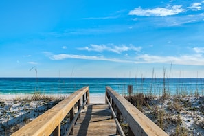 A wooden boardwalk leading to a beach with clear blue water and a bright sky. - Portside S "beauty And The Beach" 3 Bedroom Townhouse by RedAwning (Pensacola Beach)