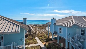 A coastal property with a clear view of the ocean, featuring a wooden deck and a pathway leading to the beach. - Portside S "beauty And The Beach" 3 Bedroom Townhouse by RedAwning (Pensacola Beach)