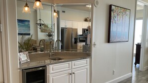 A modern kitchen with a large island, stainless steel appliances, and pendant lighting. - Simply Irresistible 2 *Gulf Front View*Make A Reservation For Fun At The Beach! (Orange Beach)