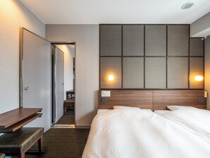 A hotel room with a bed, bedside tables, a desk, and a wall-mounted panel with lights. - SUPER HOTEL Premier JR Nara Station (Nara)