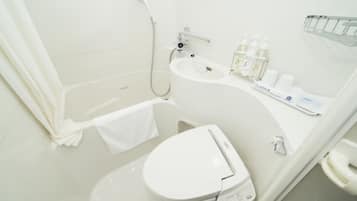 A modern bathroom with a toilet, sink, and shower.