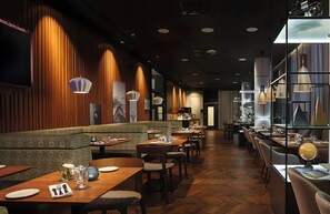 A restaurant interior with wooden paneling, a long counter, and multiple tables. - Leonardo Royal Hotel Munich Bavaria Towers (Munich)
