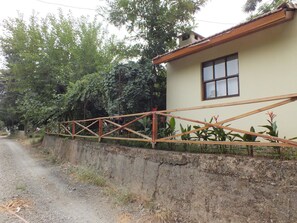 A house with a concrete wall and a wooden fence.
